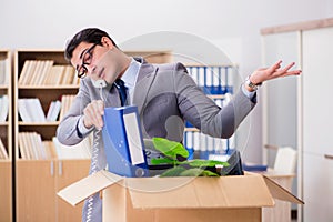 The man moving office with box and his belongings