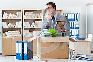 The man moving office with box and his belongings