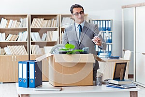 The man moving office with box and his belongings