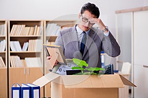 The man moving office with box and his belongings