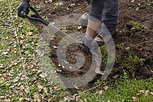 Man moving soil with a shovel in an archaeological dig, working concept