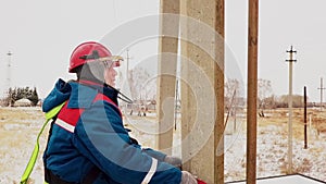 Man moving to the pole for repair voltage cable at electric station