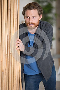 man moving wood furniture at home