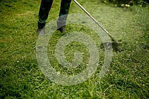 Man mowing the grass, the mower close up