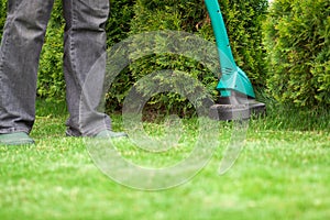 Man mowing lawn grass trimmer