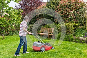 Man mowing the lawn in his garden