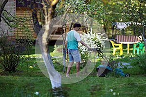 Man mowing the lawn with lawnmower