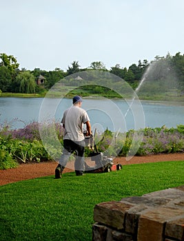 Man mowing lawn in park