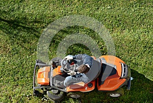 Man mowing a lawn on a ride-on mower