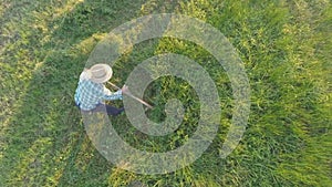 Man mowing with traditional technique