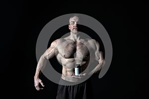 Man with muscular body hold pill jar, sport.