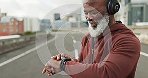 Man, music and smart watch in city for workout, cardio performance and exercise results. Happy senior african runner