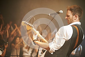 Man, musician or playing guitar at live band concert, nightclub event or party show for diversity crowd, people or