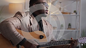 man musician song performer guitar playing home