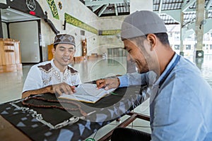 Man muslim learing to reading quran together during ramadan