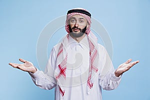 Man in muslim thobe shrugging shoulders photo
