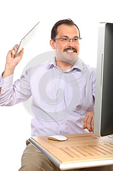 Man with mustache in anger swung keyboard on photo