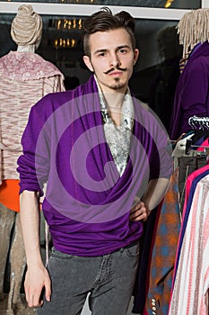 A man with a mustache and beard in a purple jacket