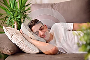 Man napping on a couch at home front view