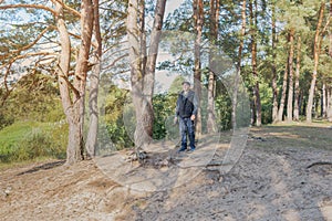 Man nature photographer taking pictures in the forest