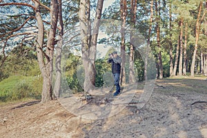 Man nature photographer taking pictures in the forest