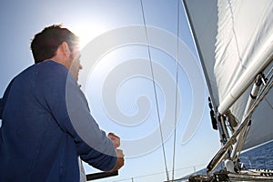 Man navigating boat with sails