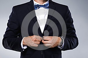 Man in navy blue suit with bow tie
