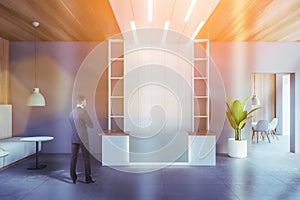 Man near white and gray reception desk