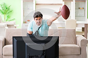 The man with neck and arm injury watching american football on tv