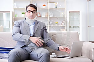 The man in neck brace cervical collar working from home teleworking