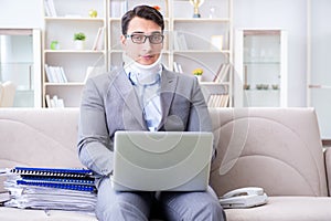 The man in neck brace cervical collar working from home teleworking