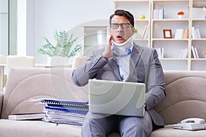 The man in neck brace cervical collar working from home teleworking