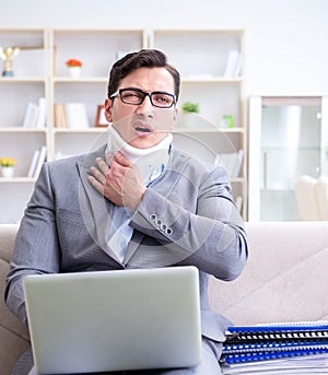 Man in neck brace cervical collar working from home teleworking