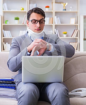 Man in neck brace cervical collar working from home teleworking