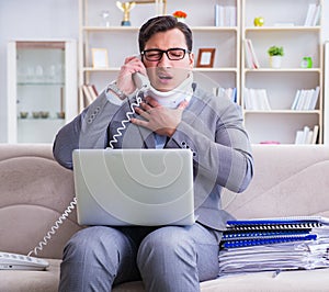 Man in neck brace cervical collar working from home teleworking