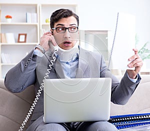 Man in neck brace cervical collar working from home teleworking