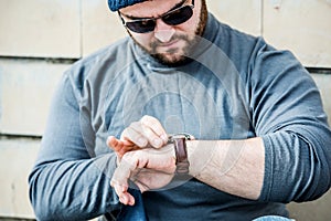 Man nervously looking at his watch