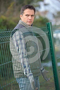 Man next to garden fence