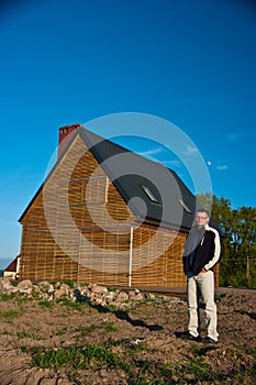 Man next to house in field