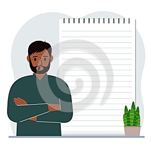 A man next to a large notepad or large notebook. The concept of filling a notebook or notepad, writing notes, time