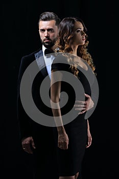 Man next to woman posing in studio