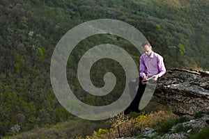 Man with notepad on stone