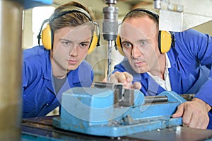 man observing metal driller