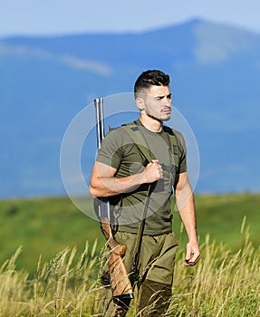 Man observing nature background. Hunter hold rifle. Hunter handsome guy with weapon. Brutal masculine hobby. Safety