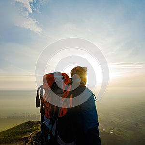 Man Observing the Splendor of Dawn on the Mountain