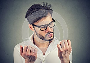 Man with obsessive compulsive disorder exploring cleanliness of hands. photo