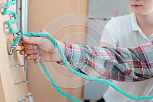 Man in occupational therapy with therapist training his dexterity