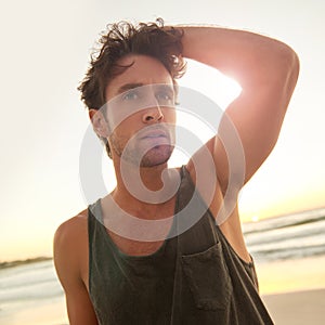 Man, ocean and thinking at sunrise on holiday in trendy clothes, remember and morning by tropical waves. Person, beach