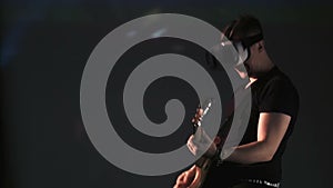Man in oculus rift playing guitar at concert
