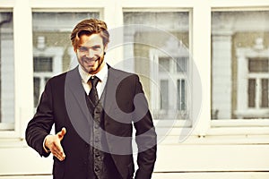 Man offer cooperation with happy face in black jacket, tie
